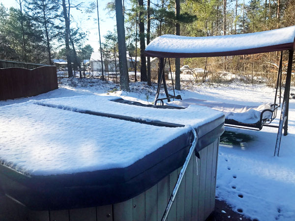 hot tub and swing covered in snow